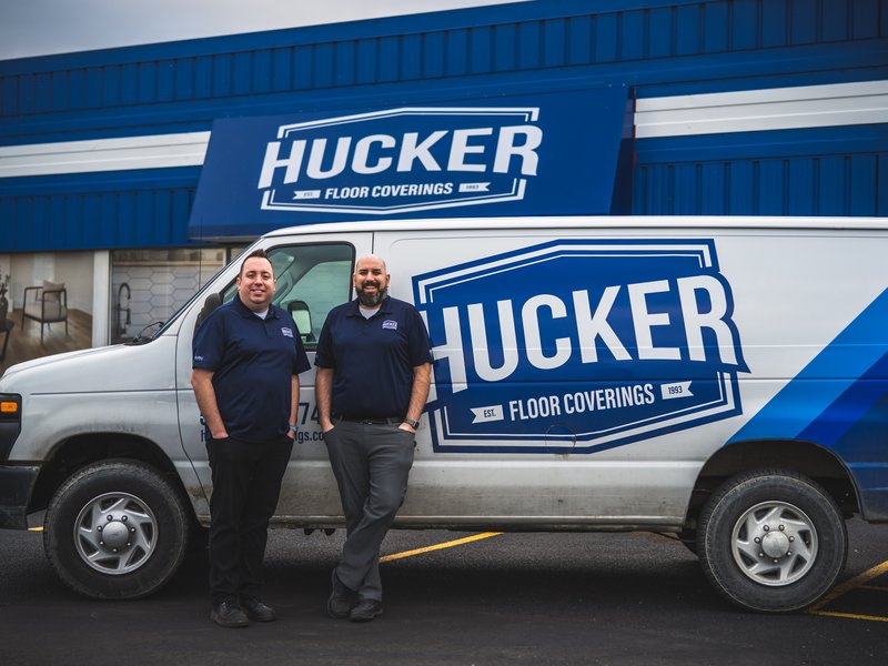 owners standing in front of van and storefront